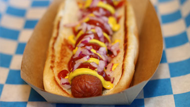 hot dog with mustard, ketchup and onion