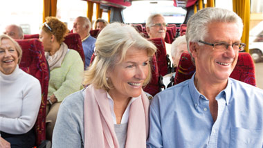 senior men and women on a bus